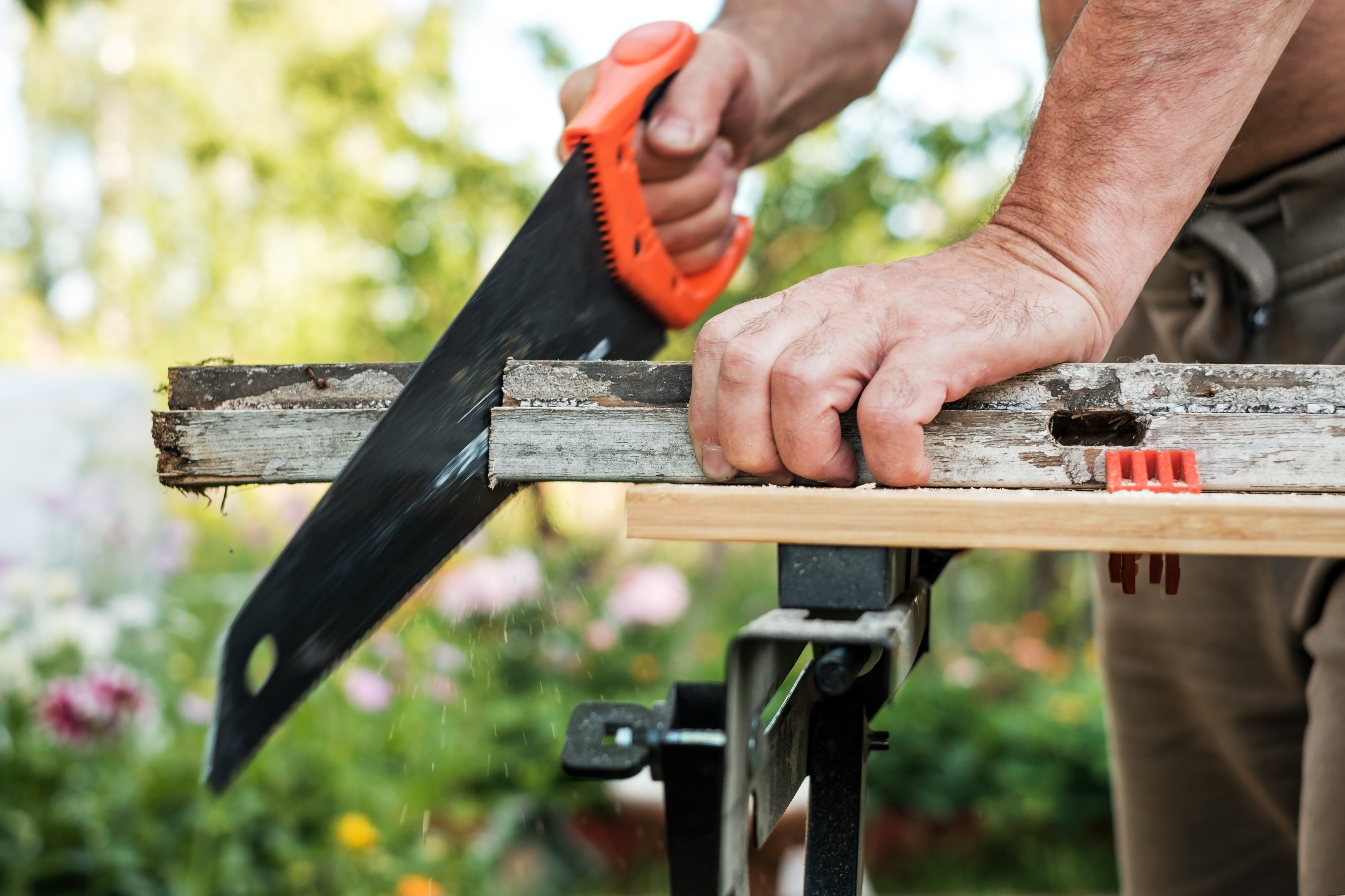 Builder using a Handsaw 